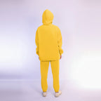 Person wearing a yellow tracksuit on a wight background