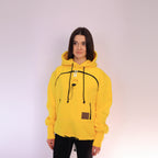 Person wearing a yellow hoodie with black drawstrings on a white background